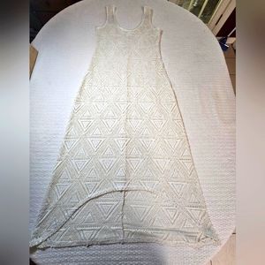 Beige cutout bathing suit cover. Mid length with hi-lo hem cut. Wear over